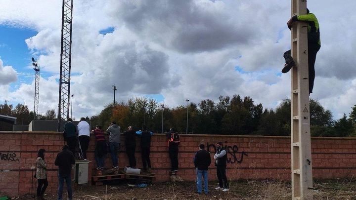 Padres tras un muro y uno suido a un poste de la luz / @JeniahOmar
