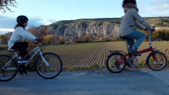 Ciclistas con el Risco de las Cuevas de Perales de Tajuña al fondo / ARACOVE / COMUNIDAD DE MADRID